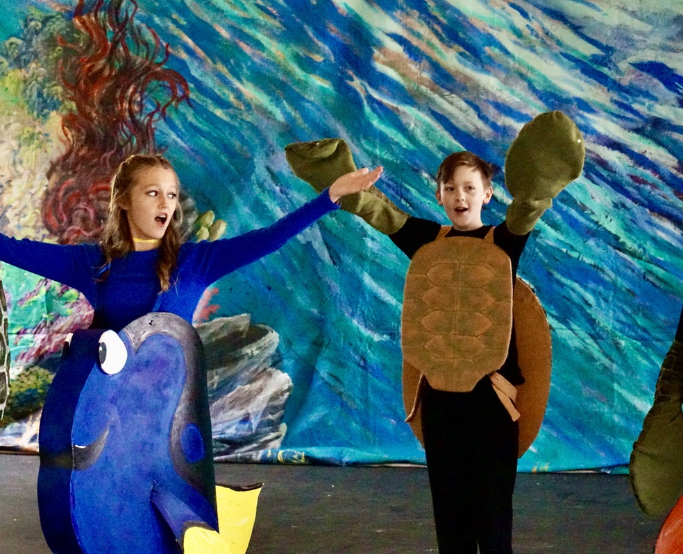 Two children dressed as sea turtles and a fish